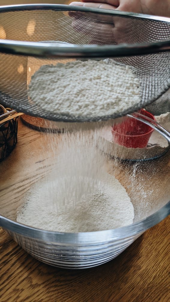 sifting flour for lemon drizzle cake