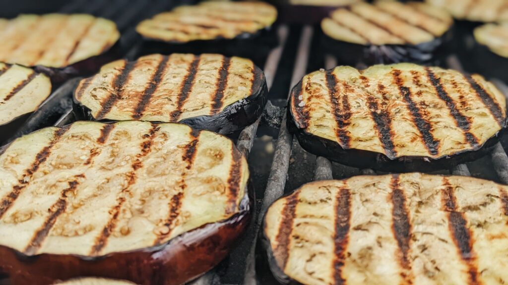 seasoned eggplant slices on the grill