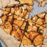 sliced sweet potato rustic galette topped with feta cheese and honey