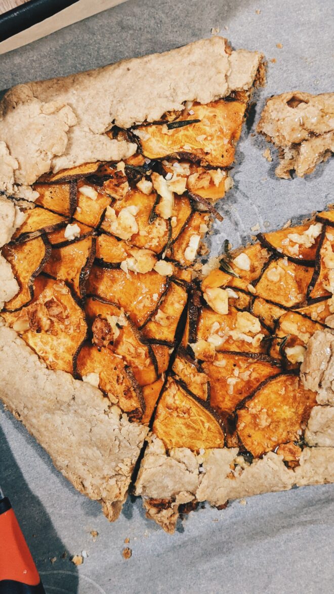 sliced sweet potato rustic galette topped with feta cheese and honey