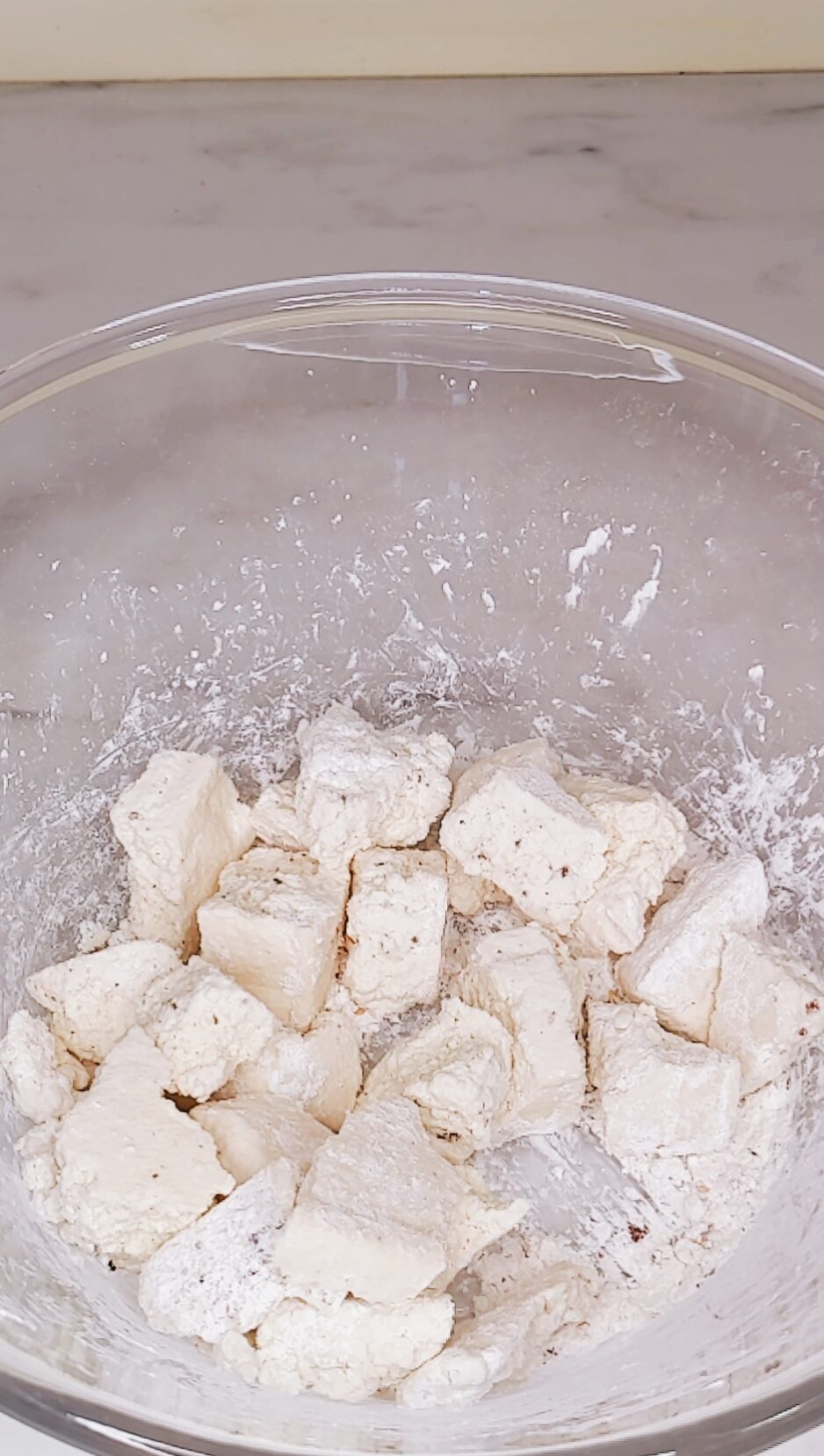 tossing the tofu in the cornstarch to make crispy tofu